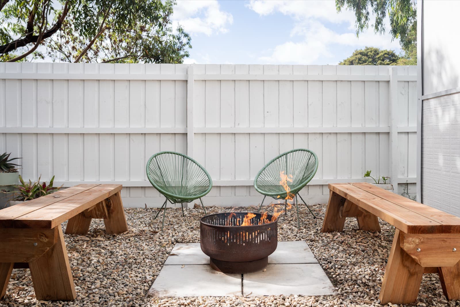 Fire pit with timber benches and Acapulco chairs at Big Isle Retreat, Phillip Island