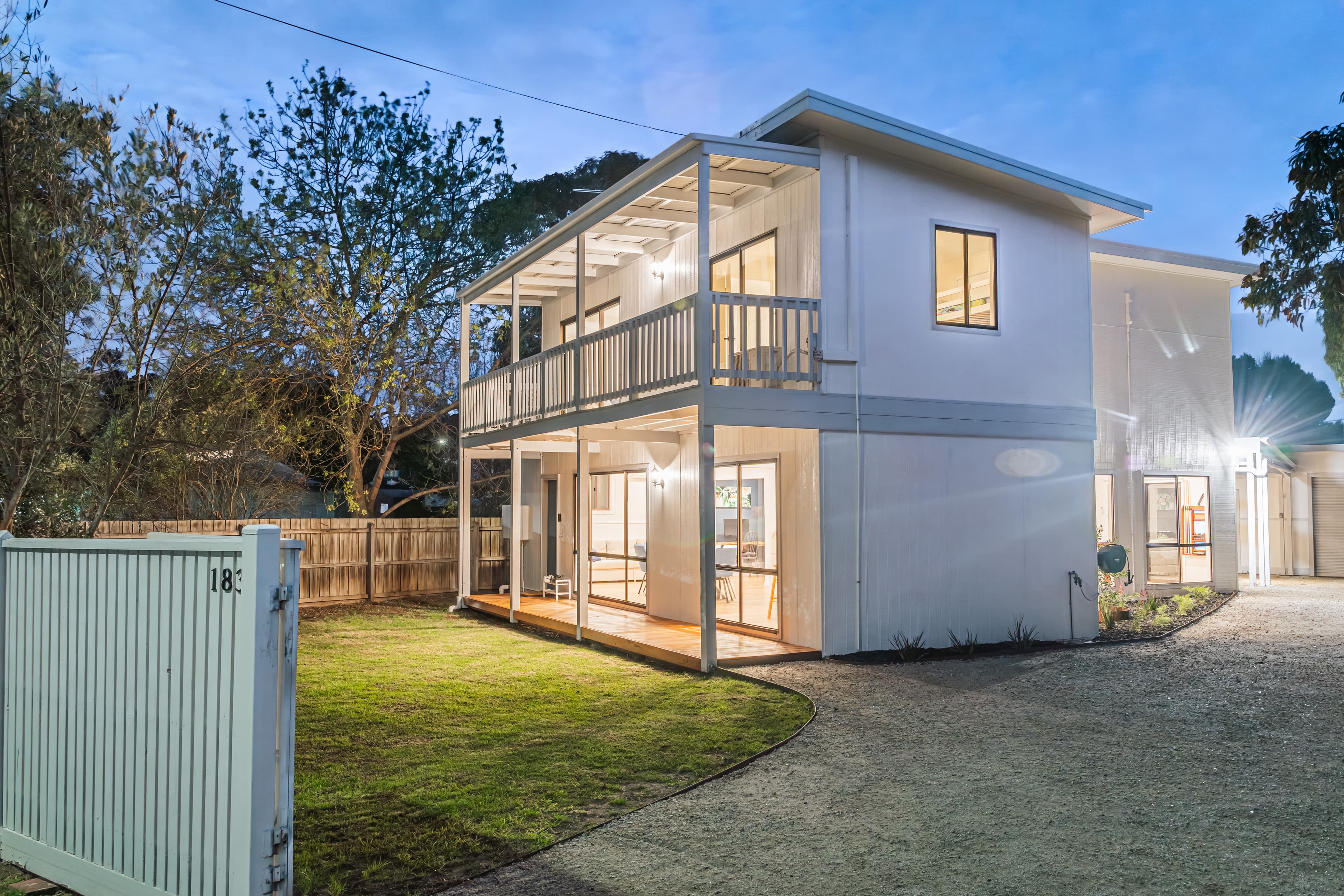 Big Isle Retreat exterior at night with warm lighting, luxury holiday house in Cowes